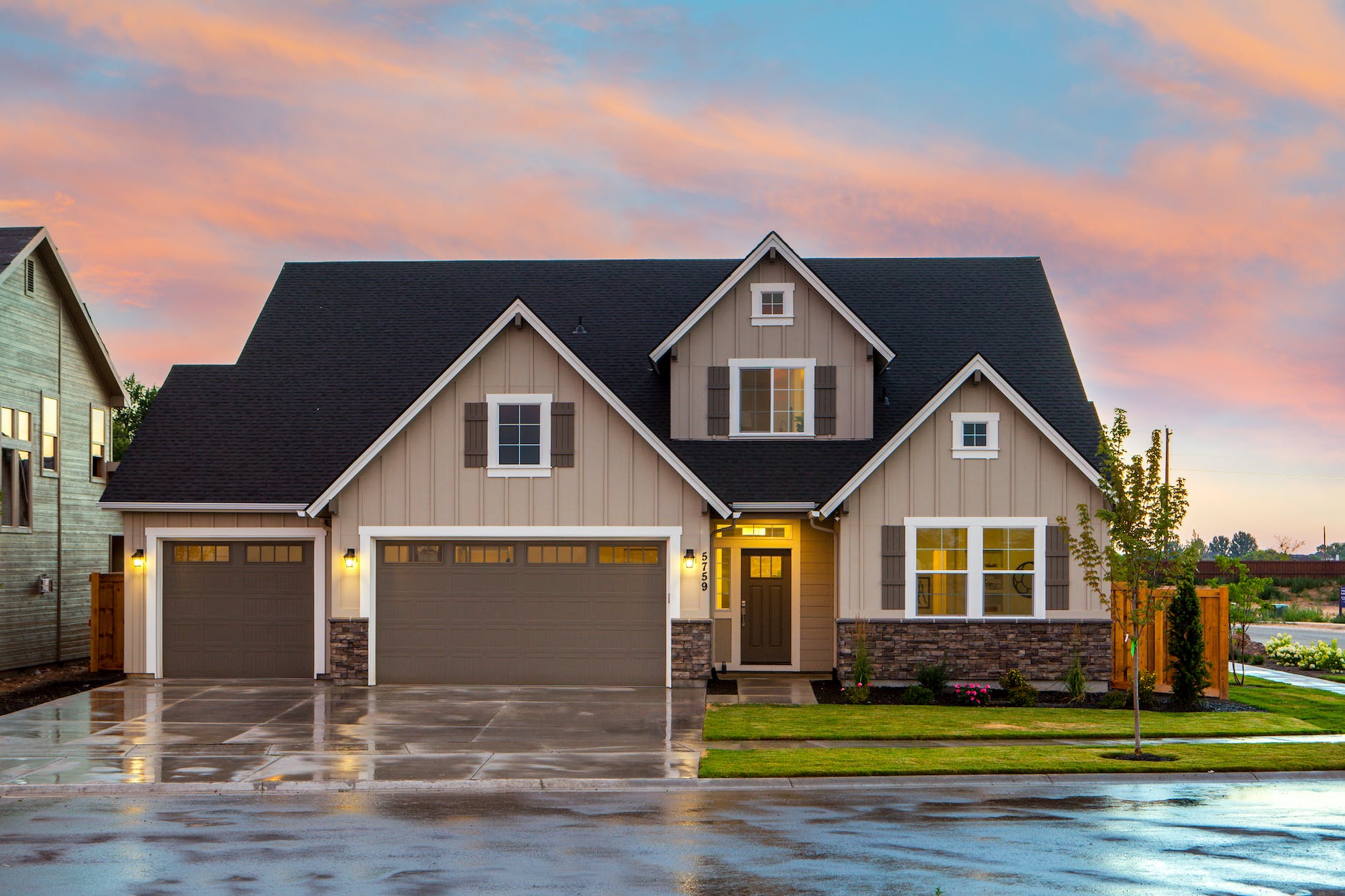 brown and gray painted house in front of road