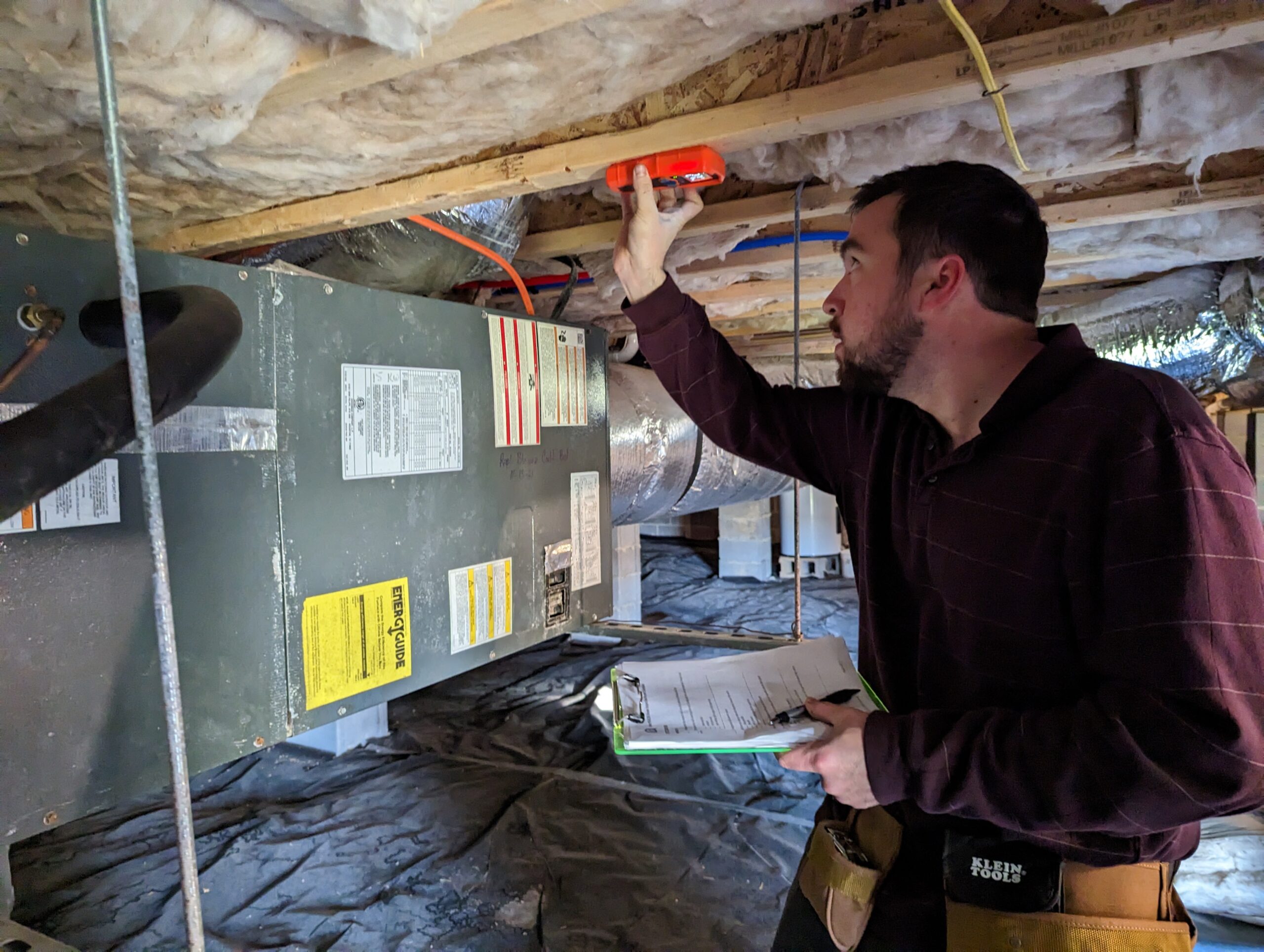 Joshua Grant, lead home inspector, investigates the crawlspace of a home.