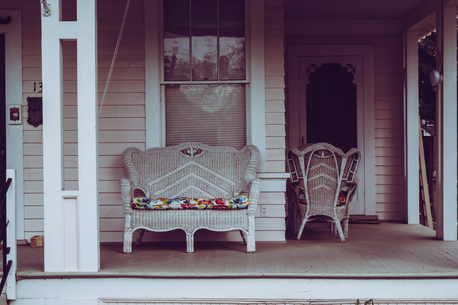 white wicker padded bench